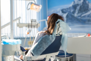 Periodontal patient relaxing in dental chair after sedation